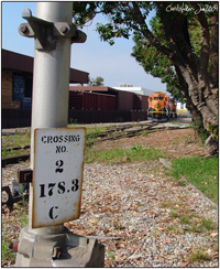 The old crossing number plate for Valencia and the BNSF 2958 off in the background alongside Weber Plywood.