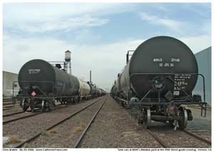 * Two long strings of tank cars seen in the Malabar yard from the 49th Street grade crossing.