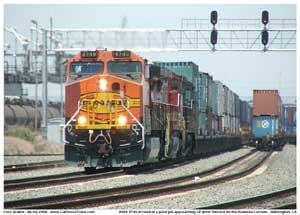 A half primered BNSF 4740 leads a stack train of mostly China Shipping containers towares CP West Thenard just across the Wilmington city line