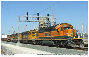 BNSF 6934 leads a train of empty steel slab cars through CP Long Beach Jct. enroute to Pasha on Pier A for loading.